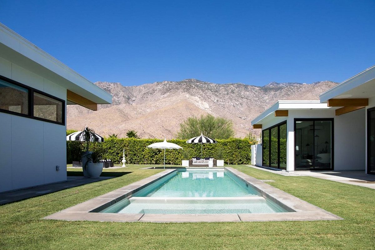 Pool courtyard between the post-and-beam wings of the 180 House Lindal home in Palm Springs