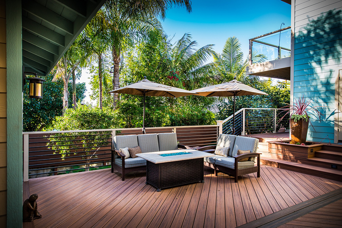 Covered outdoor living room and deck of the Tropical Zen custom home by Fassino Construction